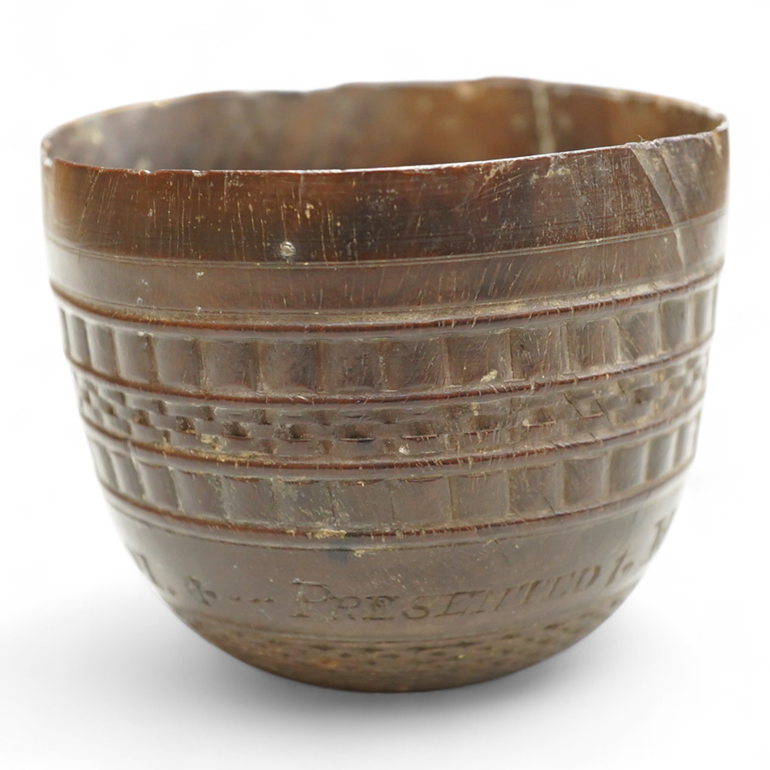 A 19th century or earlier engine-turned lignum vitae tumbler cup, engraved ‘Presented to M. S. Jones by a Friend 1834 AD 1701 +’, 6.5cm high, by repute found on the roof plate of Kenwood house London in 2012, during reno